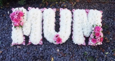 Based Letter Tribute - At Sarah Coxon Floral Design we are delighted to present this product available for flower delivery in Mid and North Norfolk. 

A based letter tribute is based in white Chrysanthemums, and is edged in hand pleated ribbon in a colour co-ordinating waterproof ribbon. The sprays of flowers on top of the letters are raised above the Chrysanthemums and includes a beautiful selection of Roses, spray Carnations and other flowers to complement the design.

Please state which word you would like the words available are Mum, Dad and Nan.

Any word can be made into a letter tribute, please contact us for further details.

Also please state the colour you woudl like in the special request box. Suggested colour schemes are red and white, Purple and white, yellow and white, pink and white and peach and white. 

The flowers are arranged in water retaining foam (oasis) to ensure maximum freshness. 

We deliver directly to all of the local funeral directors and will contact them to confirm a delivery time. 

Our flowers at Sarah Coxon Floral Design arrive fresh from the Dutch auctions every day so you can be rest assured we are using the best quality of flowers available.