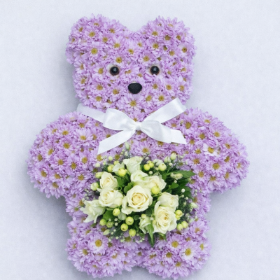 Small Teddy Bear - At Sarah Coxon Floral Design we are delighted to present this product available for flower delivery in Mid and North Norfolk. 

This specialised tribute is a small Teddy Bear (approx 18 inches in height) and is based in pink chrysanthemeums. The spray on the Teddy is a small cluster of flowers including Roses. The Bear comes complete with a satin Ribbon and bow around the neck.

This can come in a variety of colours, please specify the colour of the ribbon and flowers you would like.

This stunning floral display has been arranged in water retaining foam (oasis) to ensure maximum freshness. 

We deliver directly to all of the local funeral directors and will contact them to confirm a delivery time. 

Our flowers at Sarah Coxon Floral Design arrive fresh from the Dutch auctions every day so you can be rest assured we are using the best quality of flowers available.
