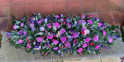 Fragrant Spray - This is a beautiful natural looking spray which is designed to rest on top of a casket. It contains a variety of mixed flowers in the colour scheme of pale pinks through to cerise pinks and lilacs through to purples.

 

This stunning spray includes Roses, Scented Lilies and Carnations as well as other seasonal flowers and foliages available at the time.

 

The Fragrant Spray has been arranged in water retaining foam (oasis) to ensure maximum freshness and is available in 3 sizes.

 

Standard size is 4ft

 

Deluxe size is 5ft

 

Luxury size will be the full length 

 

 

We deliver directly to all of the local funeral directors and will contact them to confirm a delivery time and to ensure we make the correct size if a full sized spray is ordered.

 

Our flowers at Sarah Coxon Floral Design arrive fresh from the Dutch auctions every day so you can be rest assured we are using the best quality of flowers available.

 

At Sarah Coxon Floral Design we are delighted to present this product available for flower delivery in Mid and North Norfolk.