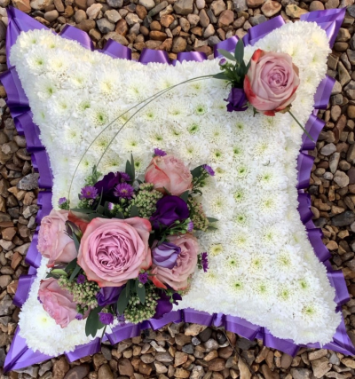 Based Cushion - At Sarah Coxon Floral Design we are delighted to present this product available for flower delivery in Mid and North Norfolk. 

A based cushion is a traditional funeral tribute, it is based in white Chrysanthemums, and is edged in hand pleated ribbon in a colour co-ordinating waterproof ribbon. The spray of flowers on top of the cushion is raised above the Chrysanthemums and includes a beautiful selection of Roses, spray Carnations and other flowers to complement the design. 

The flowers are arranged in water retaining foam (oasis) to ensure maximum freshness. 

Standard - approx size 14"

Deluxe - approx size 17"

Luxury - approx size 20"

We deliver directly to all of the local funeral directors and will contact them to confirm a delivery time. 

Our flowers at Sarah Coxon Floral Design arrive fresh from the Dutch auctions every day so you can be rest assured we are using the best quality of flowers available. 

If you would like to choose a colour scheme, please state this in the special request box. Suggested colour schemes are red and white, yellow and white, pink and white and peach and white. If no colours have been selected we will use the same colours as the picture.