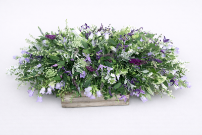 Rustic and Wild spray - This is a natural looking spray which definitely has the wild natural look. It is designed to rest on top of a casket. It contains a variety of mixed flowers in muted colour scheme.

This stunning spray includes Campanula,
Lisianthus, Clematis and Ammi  together with other seasonal flowers and foliages which can be found in the great outdoors to enhance and complement the style of this beautiful floral tribute.

 
Please note due to the nature of this spray, the flowers are all seasonal and if they are not available, we will use similar flowers which will not alter the design, colour or beauty of this spray.

 
This Spray has been arranged in water retaining foam (oasis) to ensure maximum freshness and is available in 3 sizes.

 
Standard size is 3ft
 
Classic size is 4ft
 
Grande size is 5ft
 
 
 
We deliver directly to all of the local funeral directors and will contact them to confirm a delivery time and to ensure we make the correct size if a full sized spray is ordered.